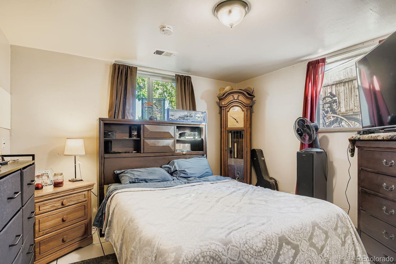 7111 Raleigh Street Westminster, CO 80030 - Photo 20 of 38 a bedroom with a bed and a window