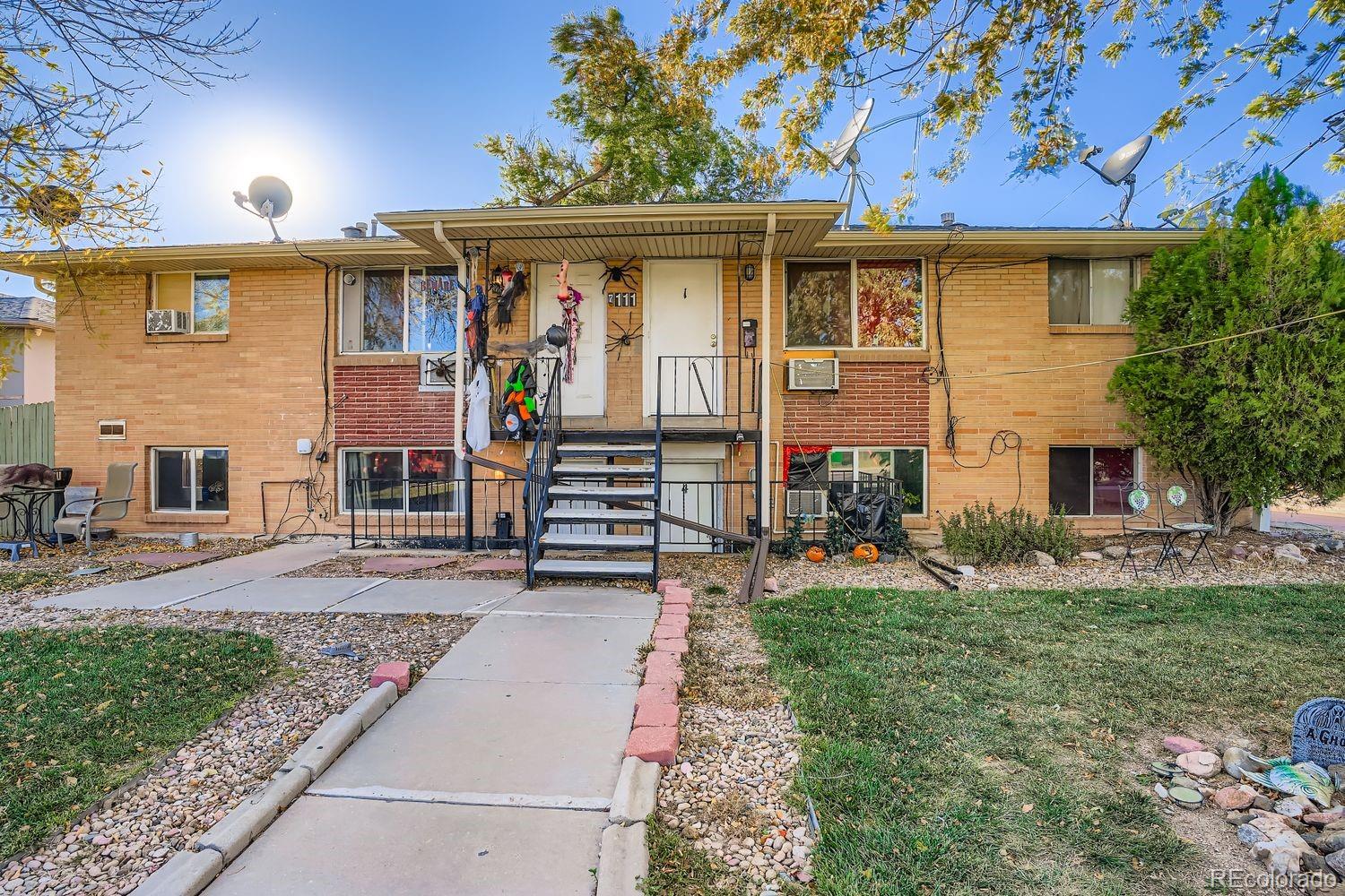 7111 Raleigh Street Westminster, CO 80030 - Photo 2 of 38 a front view of a house with garden