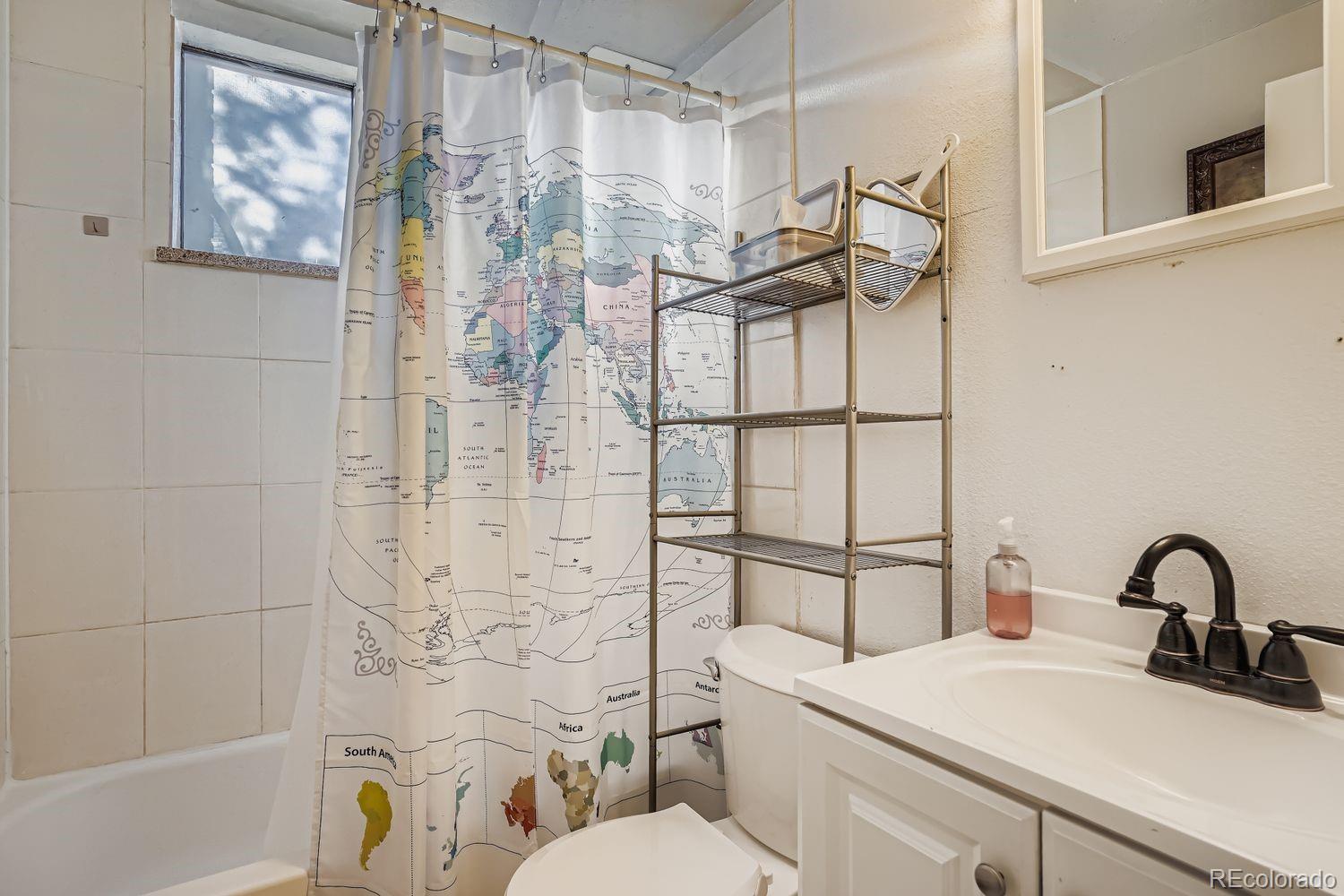 7111 Raleigh Street Westminster, CO 80030 - Photo 22 of 38 a bathroom with a sink toilet and shower