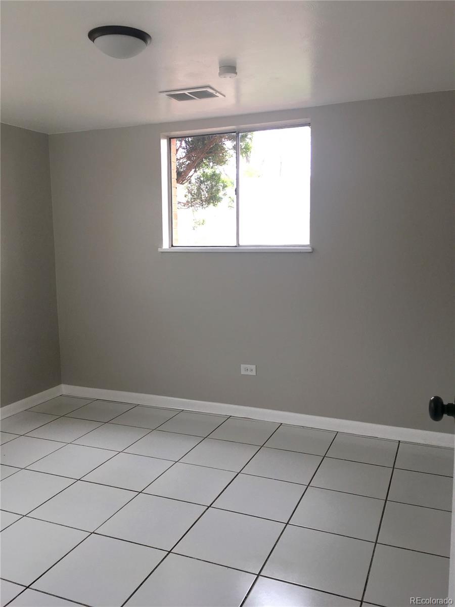 7111 Raleigh Street Westminster, CO 80030 - Photo 24 of 38 an empty room with windows