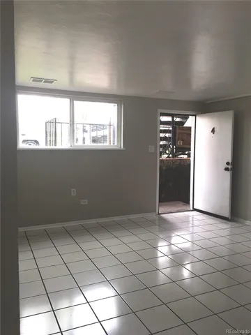 an empty room with windows and painted walls