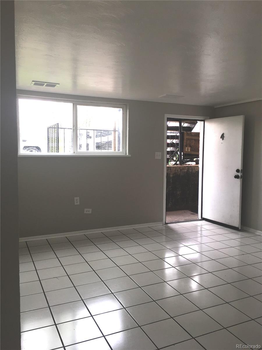 7111 Raleigh Street Westminster, CO 80030 - Photo 30 of 38 an empty room with windows and painted walls