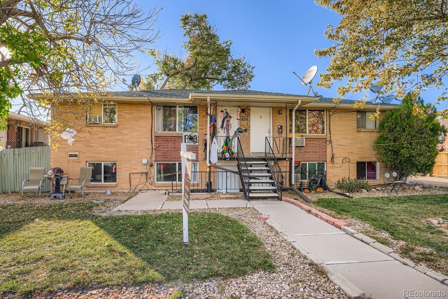 7111 Raleigh Street Westminster, CO 80030 - Photo 3 of 38 a front view of a house with garden