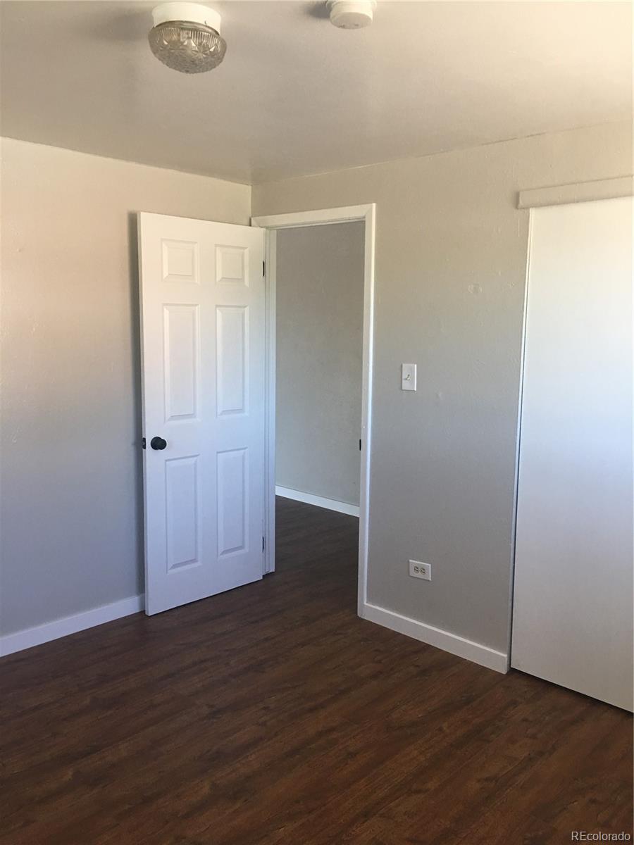 7111 Raleigh Street Westminster, CO 80030 - Photo 35 of 38 an empty room with wooden floor