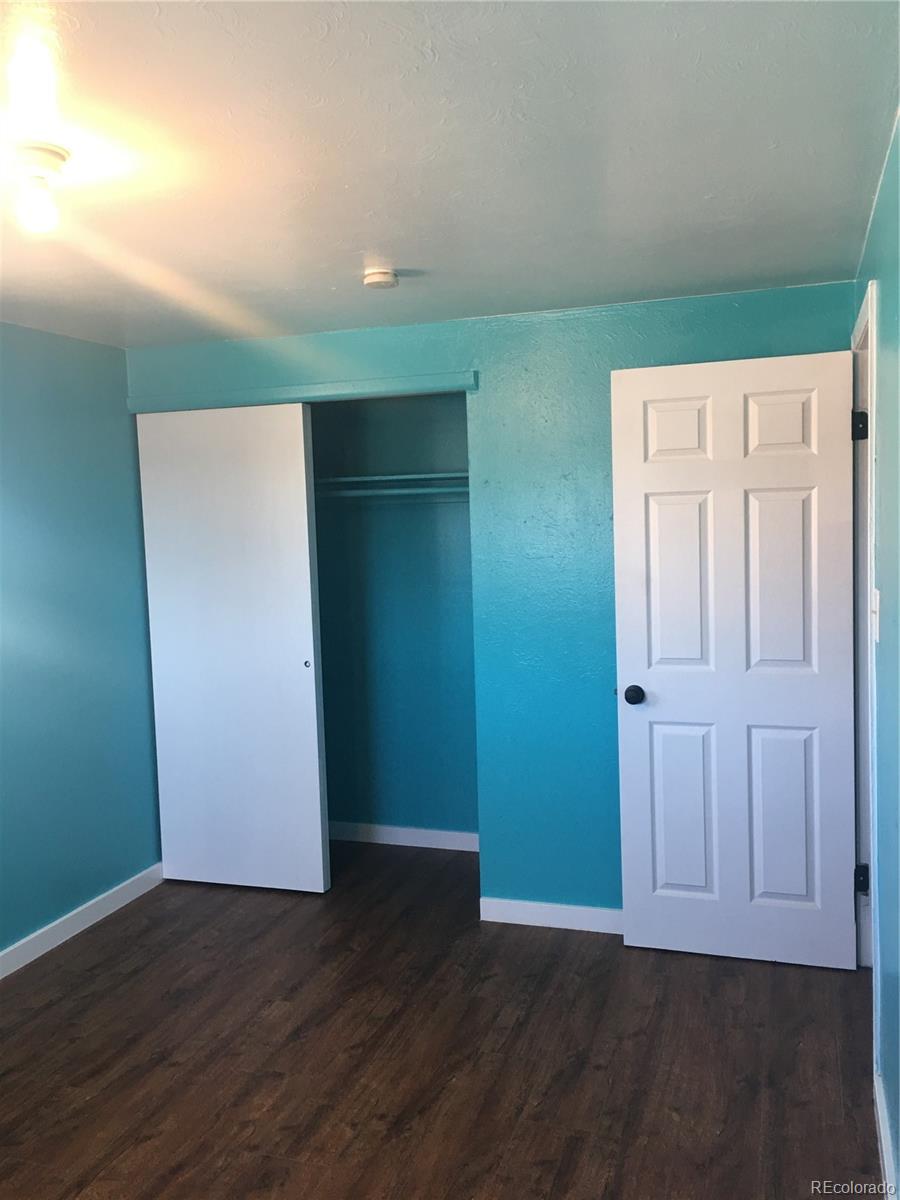7111 Raleigh Street Westminster, CO 80030 - Photo 36 of 38 an empty room with wooden floor and closet