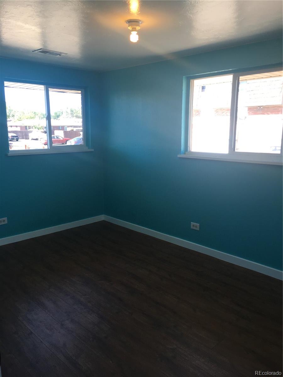 7111 Raleigh Street Westminster, CO 80030 - Photo 38 of 38 a view of an empty room with wooden floor and a window