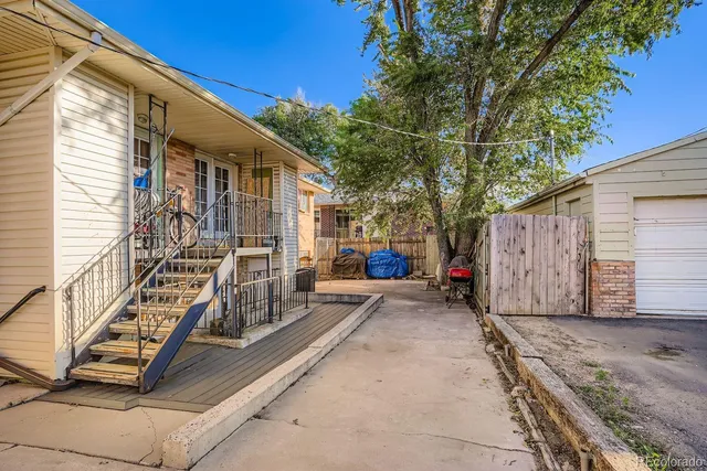 a view of a house with wooden fence