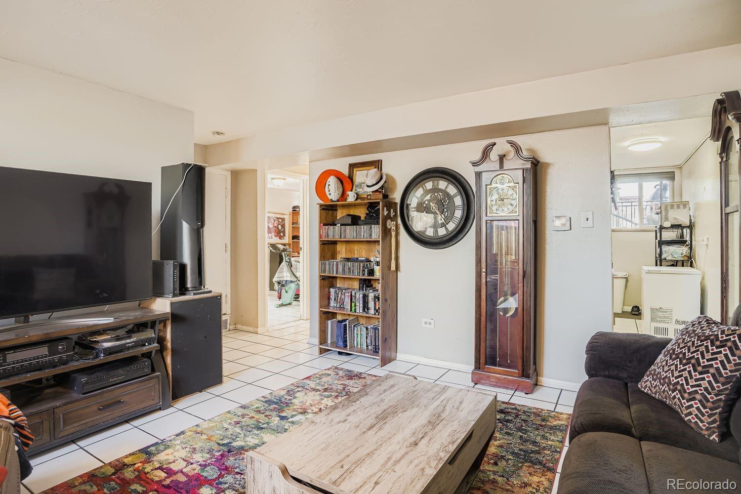 7111 Raleigh Street Westminster, CO 80030 - Photo 9 of 38 a living room with furniture and a flat screen tv