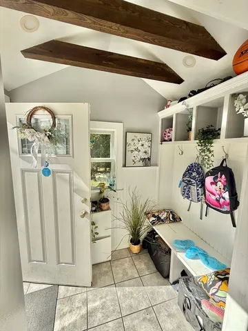 a kitchen with stainless steel appliances a refrigerator a stove a dining table and chairs with wooden floor