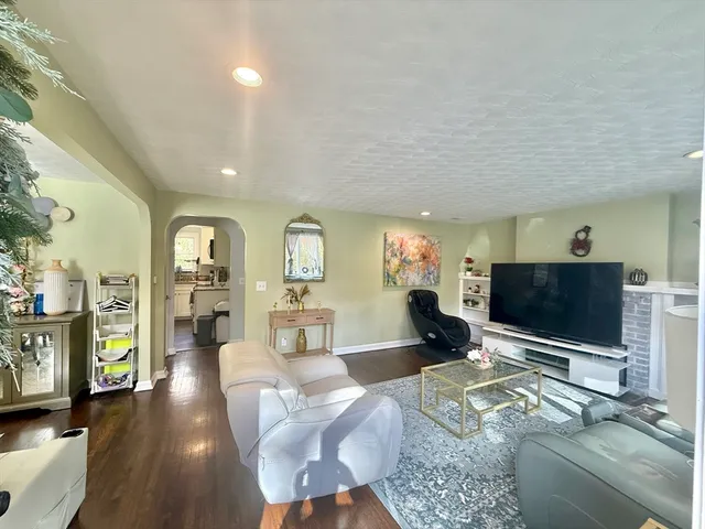 a view of a room with wooden floor and a ceiling fan