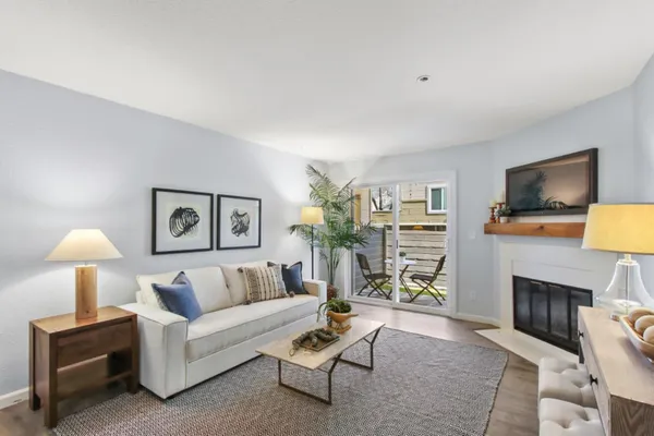 a living room with furniture a fireplace and a flat screen tv
