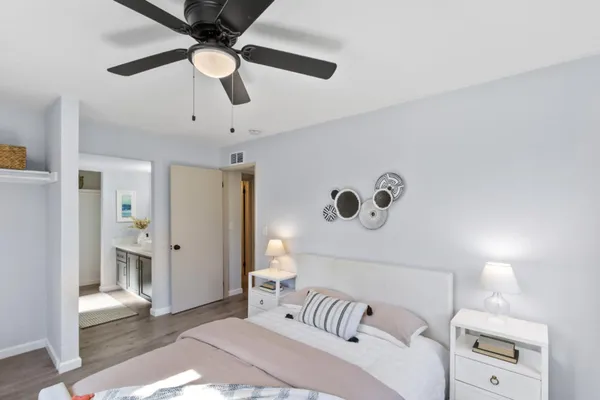 a bedroom with a bed and a chandelier