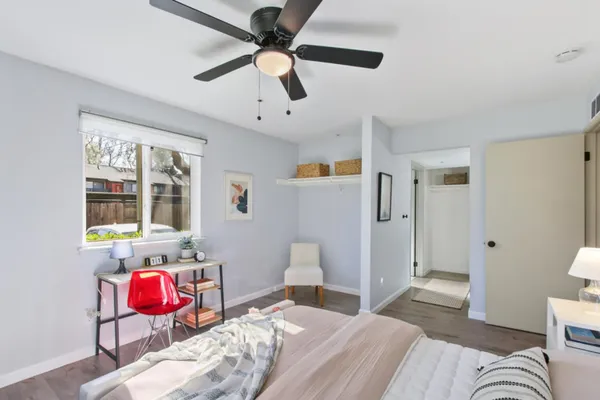 a bedroom with a bed and a chandelier