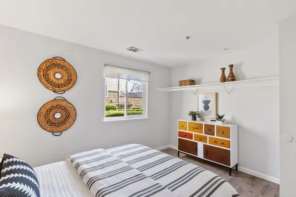 a bedroom with a bed and a window