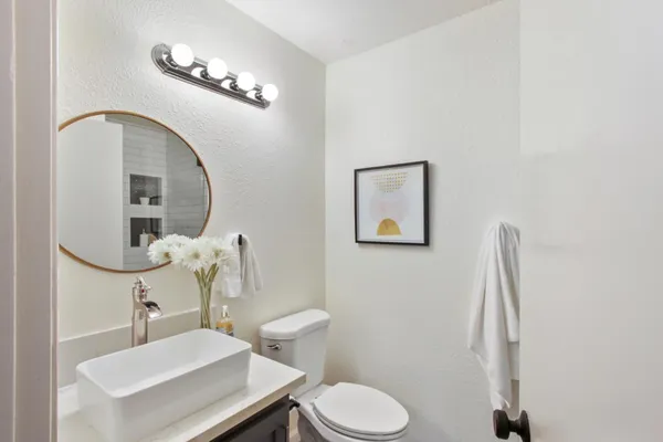 a bathroom with a toilet sink and mirror