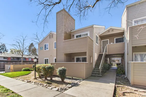 a view of a patio with table and chairs near a yard