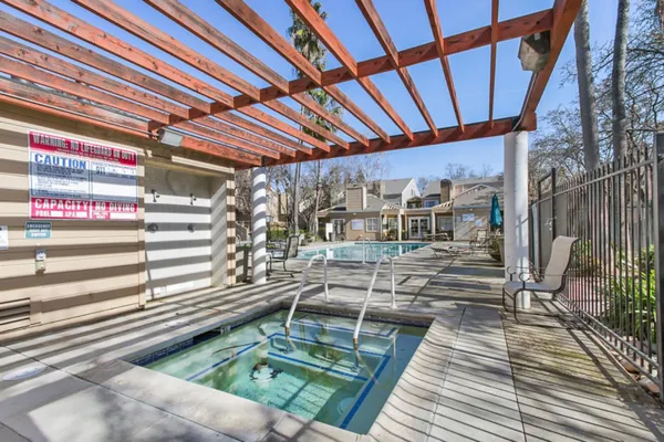 a view of a patio with table and chairs with wooden floor and fence