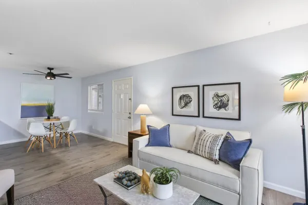 a living room with furniture and a wooden floor