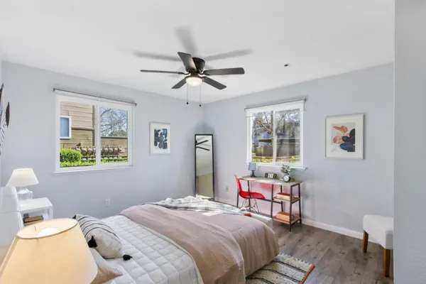 a bedroom with a bed and wooden floor