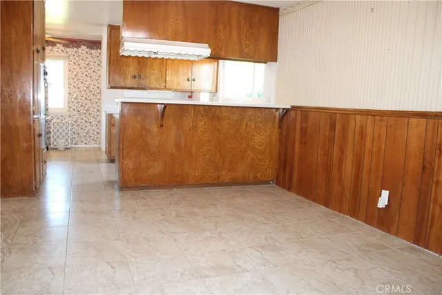 a view of an empty room with a fireplace and a window