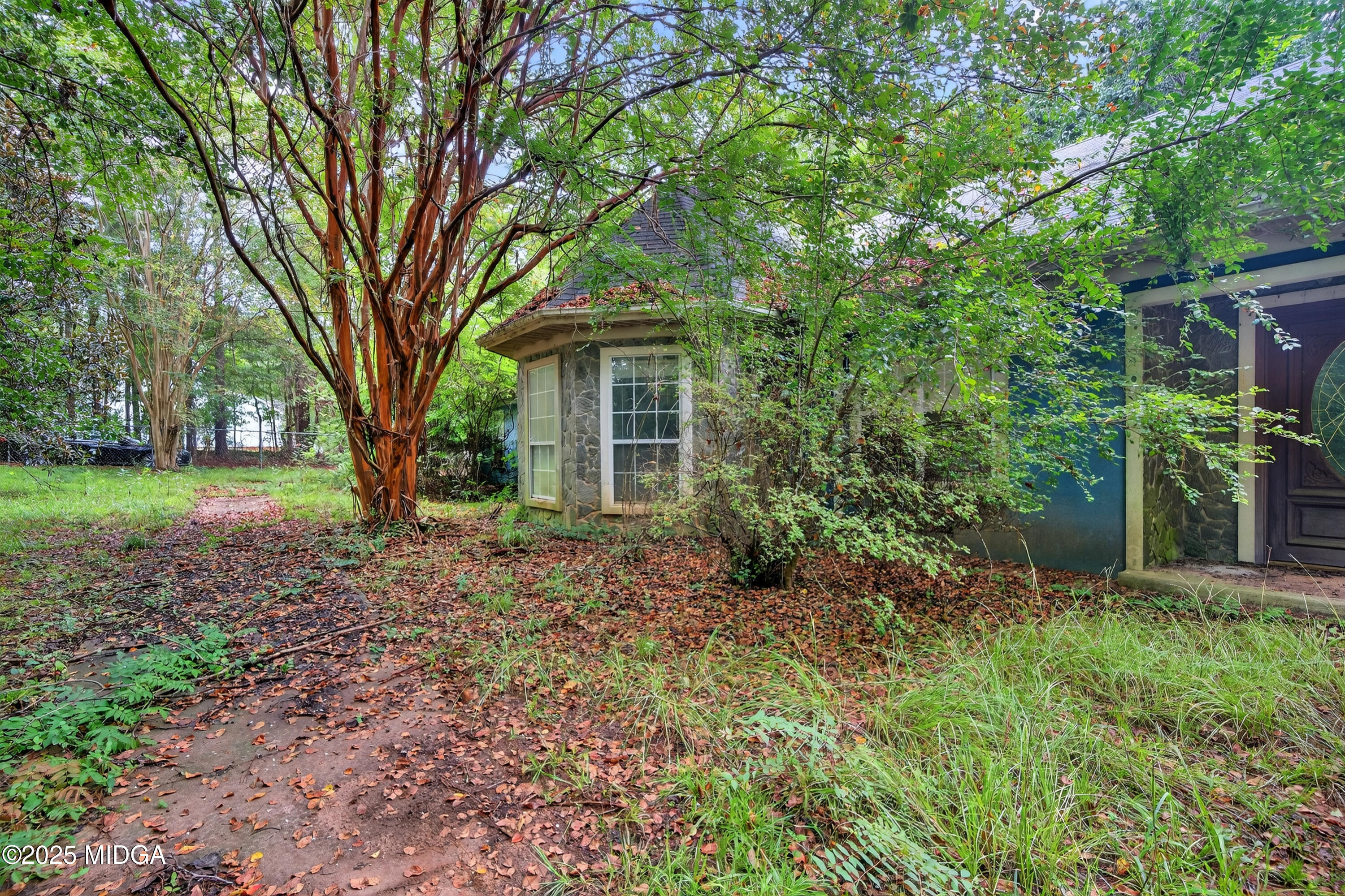615 Lite-N-Tie Road Gray, GA 31032 - Photo 5 of 19 a view of a house with a tree in the yard