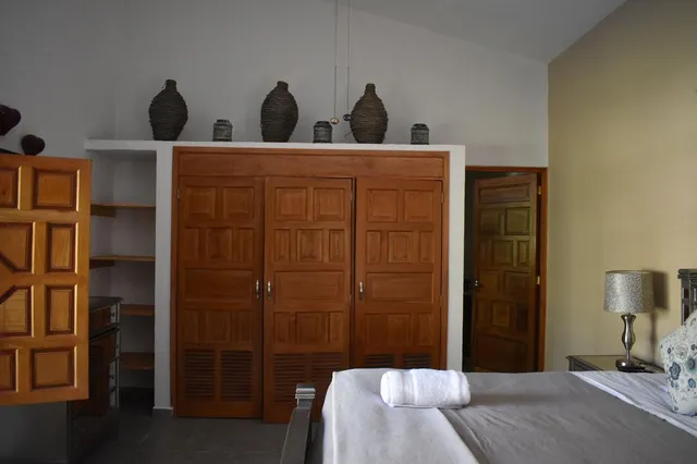 a kitchen with kitchen island granite countertop a sink a stove and a refrigerator