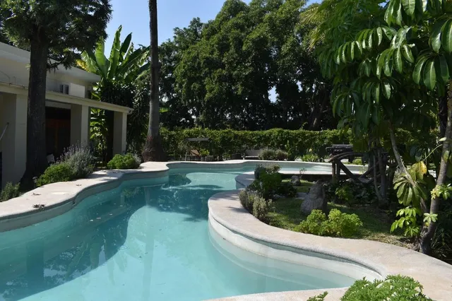 a view of a couches in a patio with a yard