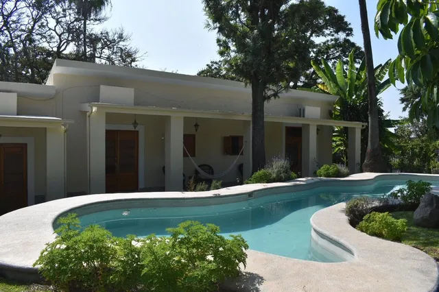 a view of a house with swimming pool and yard