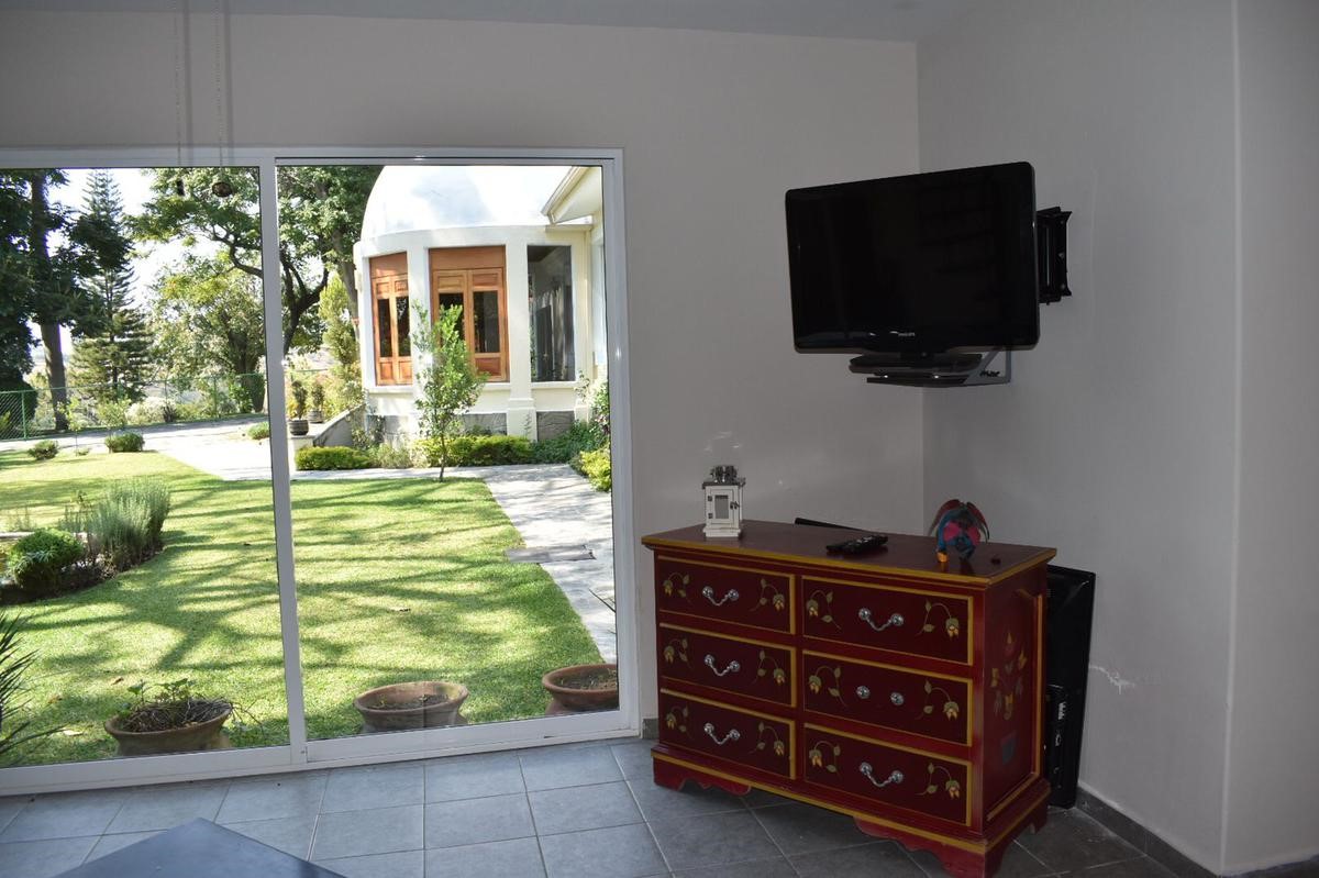23 Privada Vergel Hillview, IL 62050 - Photo 4 of 17 a living room with a flat screen tv and a fireplace