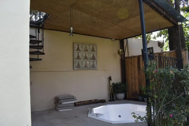 a view of a porch with a floor to ceiling window and tree