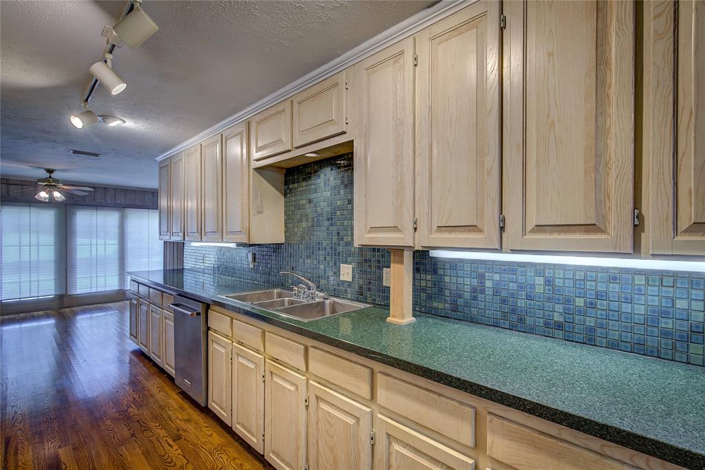 18 Mullaney Road Greenville, TX 75402 - Photo 12 of 37 a kitchen with stainless steel appliances granite countertop a sink a stove and cabinets