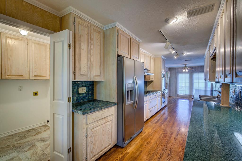 18 Mullaney Road Greenville, TX 75402 - Photo 13 of 37 a kitchen with stainless steel appliances granite countertop a refrigerator and a stove