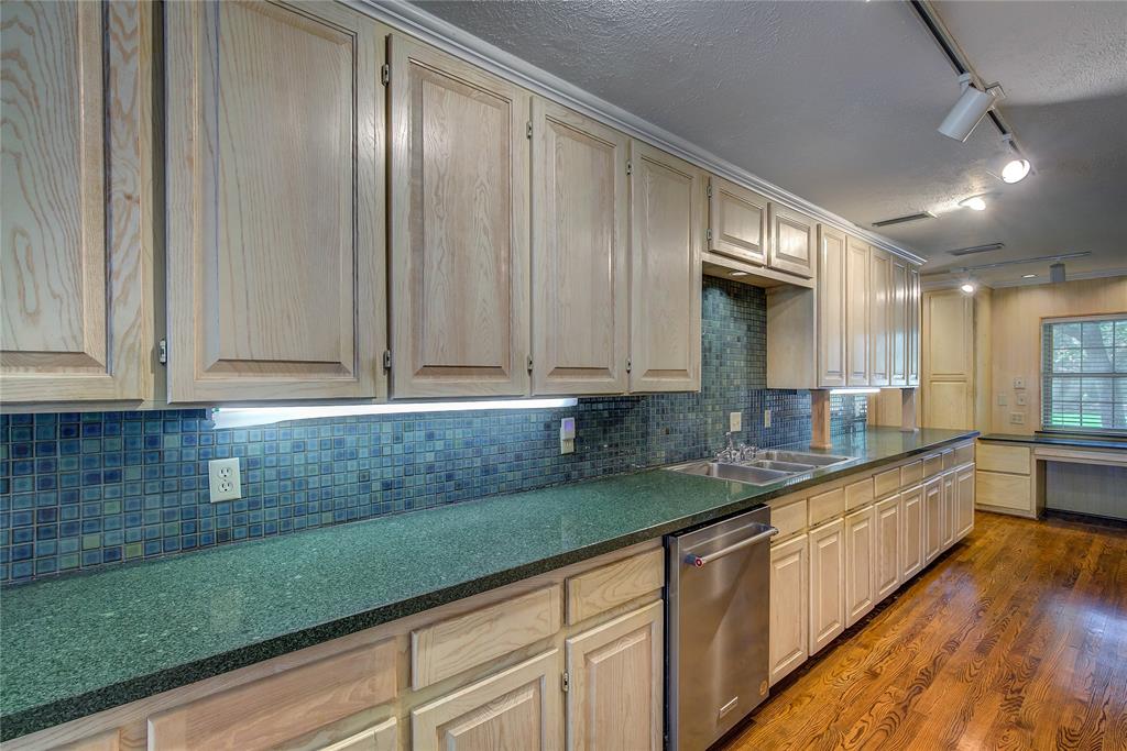 18 Mullaney Road Greenville, TX 75402 - Photo 16 of 37 a kitchen with stainless steel appliances granite countertop a sink a stove and cabinets