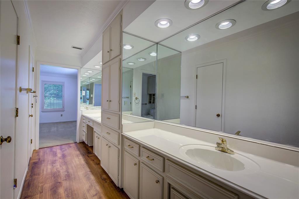 18 Mullaney Road Greenville, TX 75402 - Photo 20 of 37 a spacious bathroom with a double vanity sink a mirror and a shower