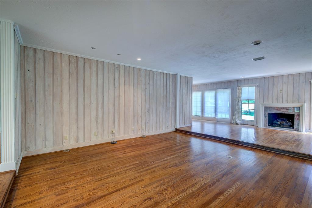 18 Mullaney Road Greenville, TX 75402 - Photo 3 of 37 a view of an empty room with wooden floor and a fireplace