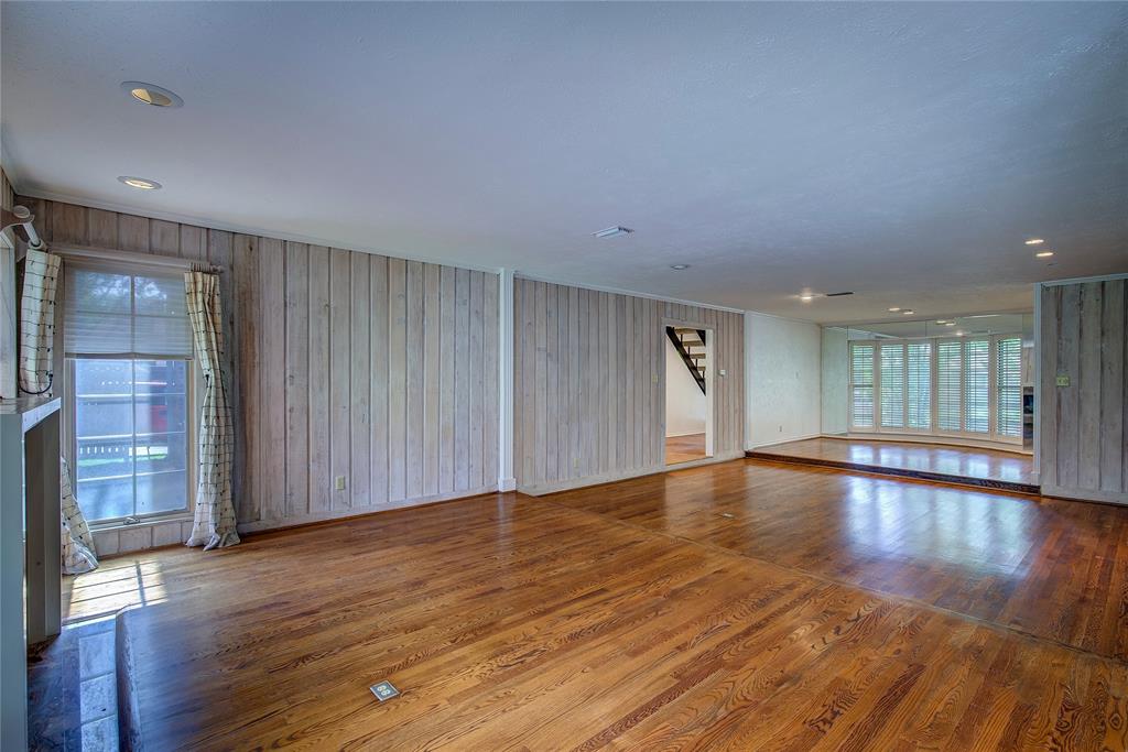 18 Mullaney Road Greenville, TX 75402 - Photo 5 of 37 a view of an empty room with wooden floor and a window