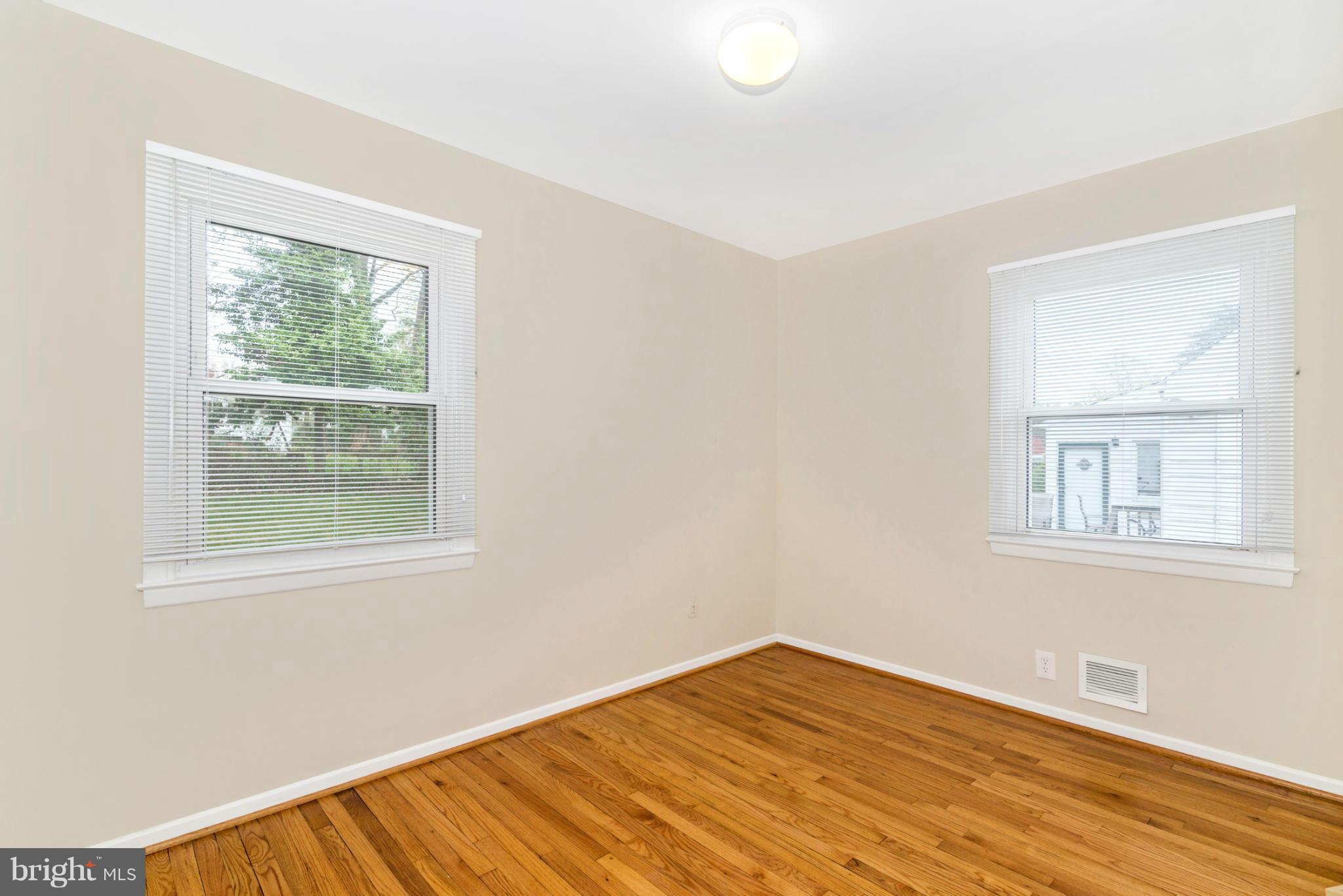 2801 Weisman Road Silver Spring, MD 20902 - Photo 12 of 30 an empty room with wooden floor and windows