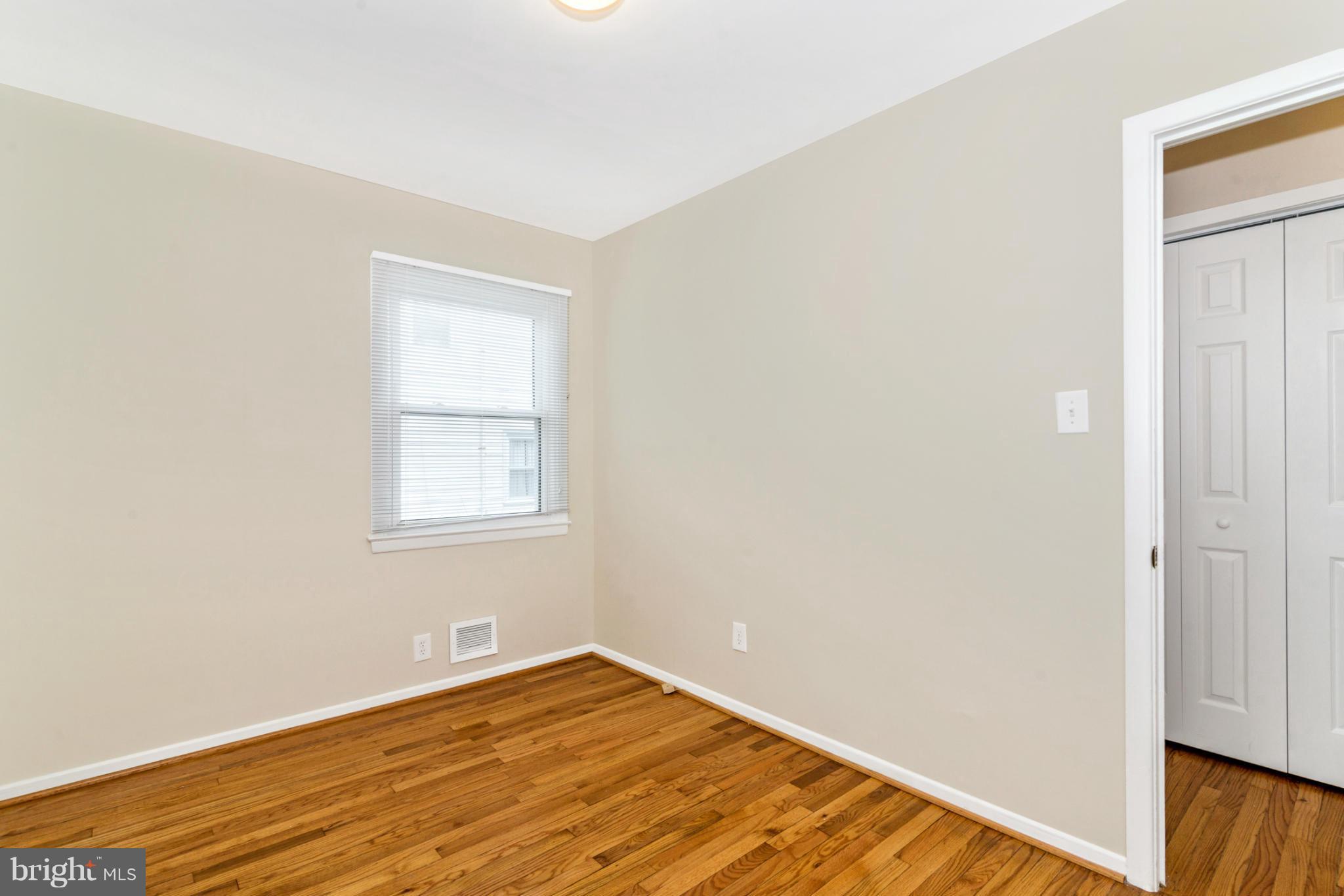 2801 Weisman Road Silver Spring, MD 20902 - Photo 13 of 30 an empty room with wooden floor and windows