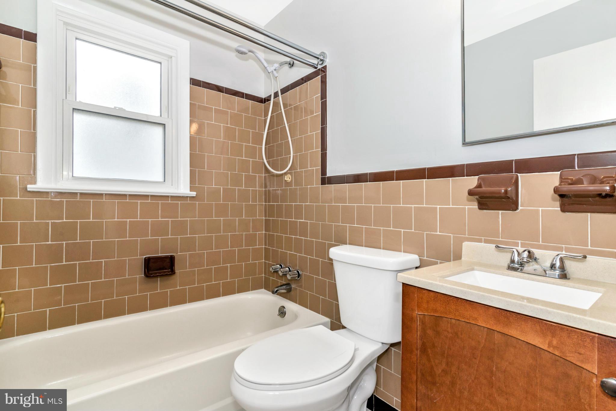 2801 Weisman Road Silver Spring, MD 20902 - Photo 15 of 30 a bathroom with a sink a toilet and shower
