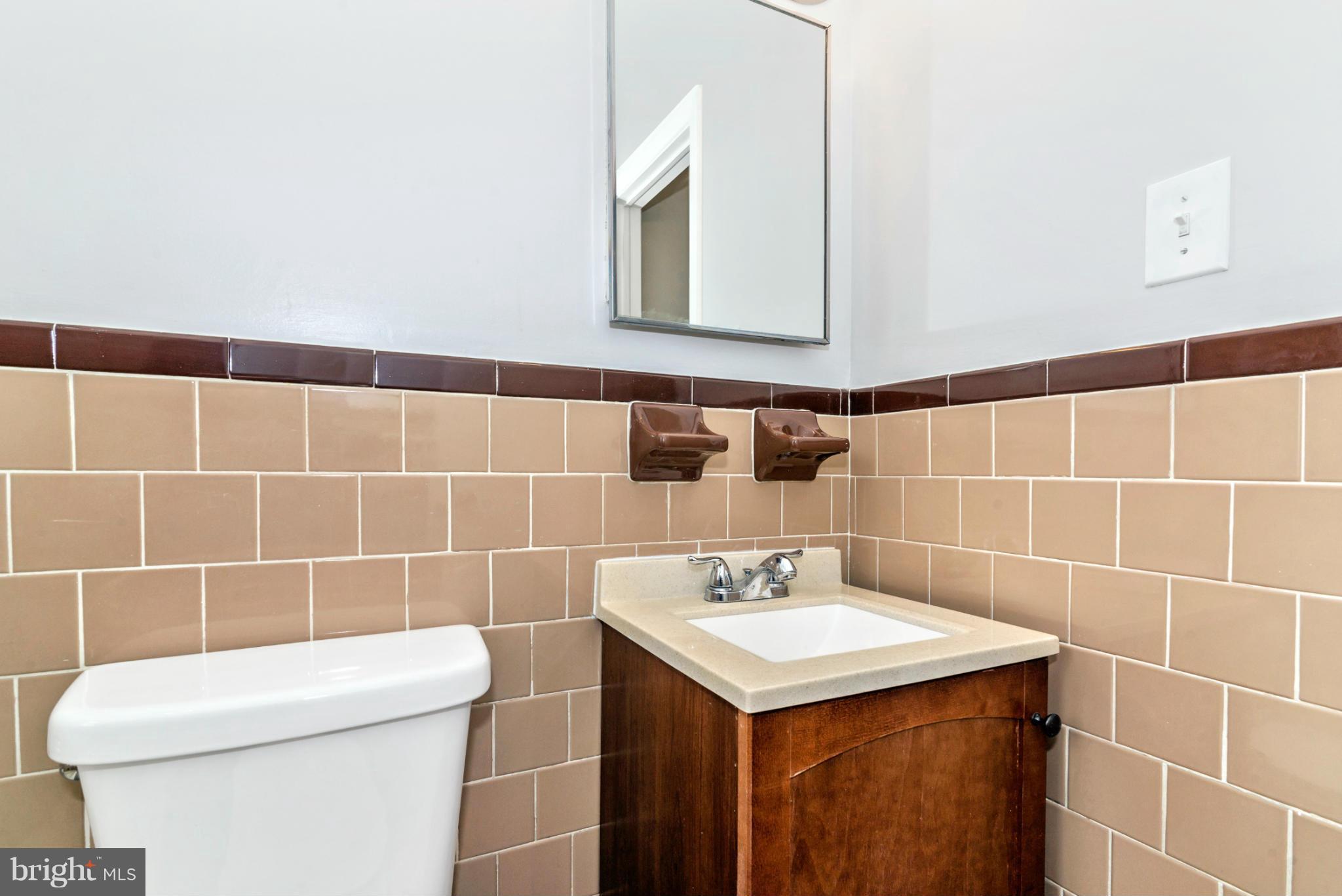 2801 Weisman Road Silver Spring, MD 20902 - Photo 16 of 30 a bathroom with a sink a toilet and a mirror
