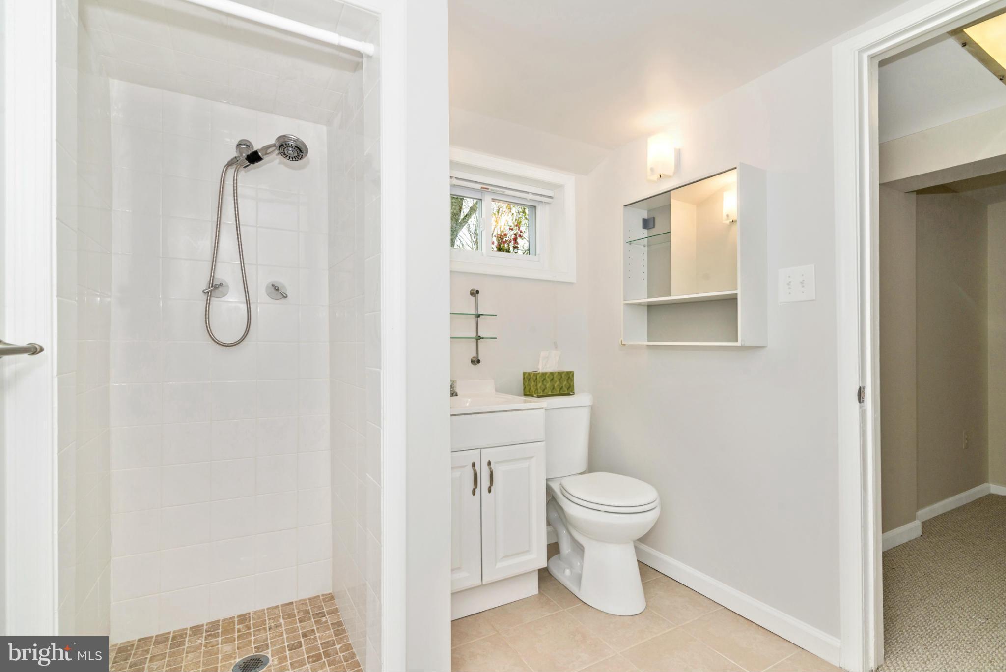 2801 Weisman Road Silver Spring, MD 20902 - Photo 24 of 30 a bathroom with a granite countertop toilet a sink and mirror