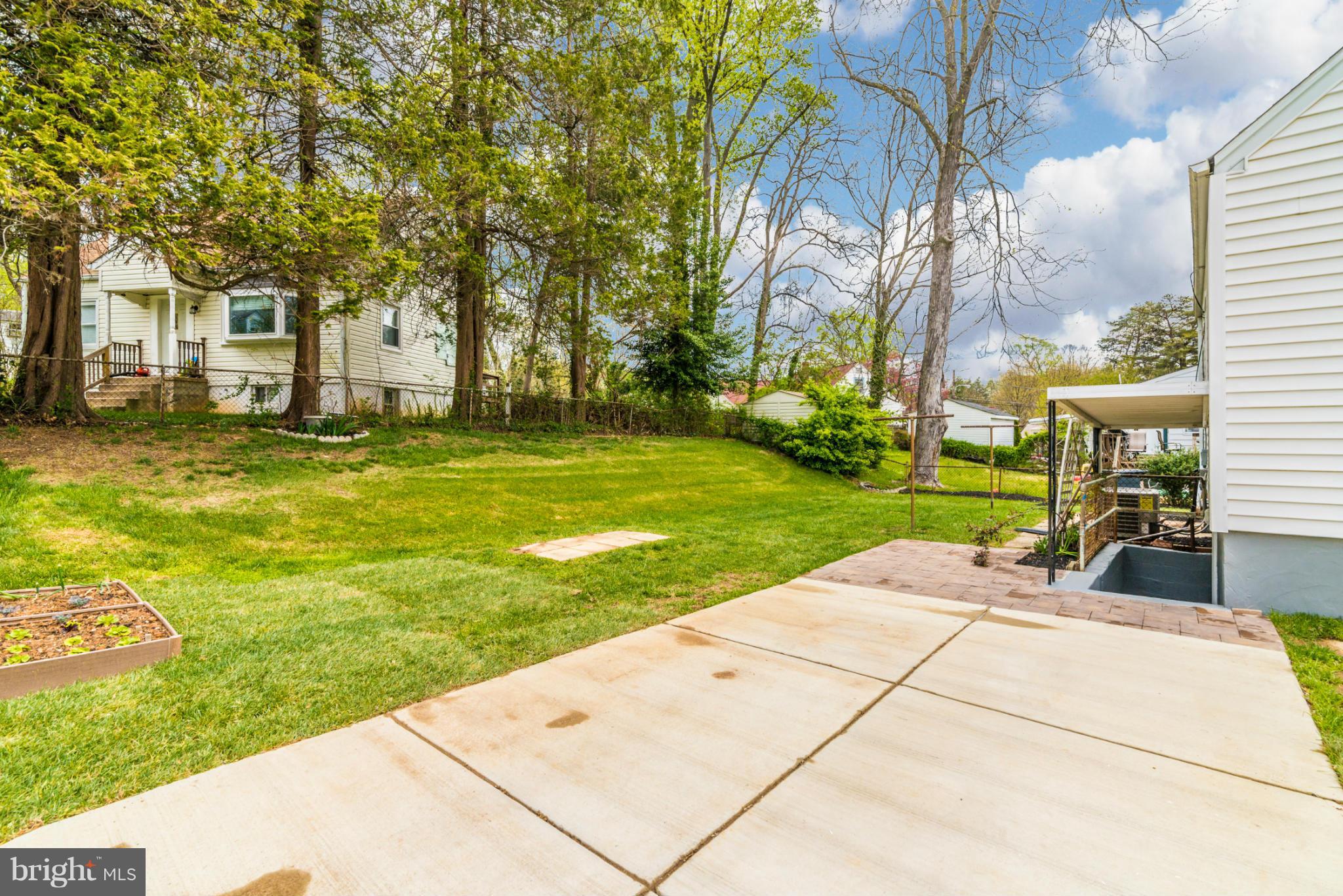 2801 Weisman Road Silver Spring, MD 20902 - Photo 30 of 30 a view of a patio with a table and chairs under an umbrella