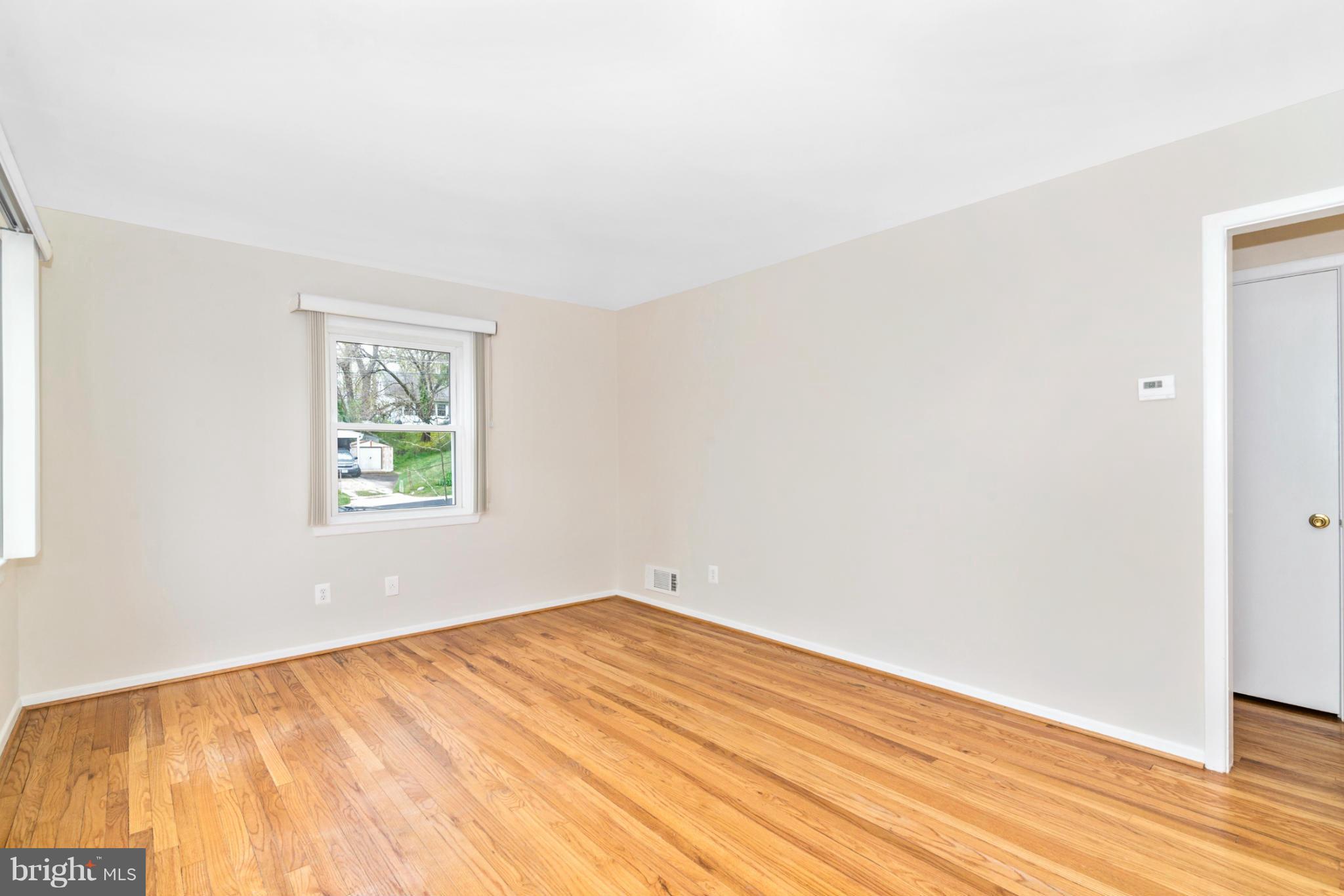 2801 Weisman Road Silver Spring, MD 20902 - Photo 4 of 30 an empty room with wooden floor and windows