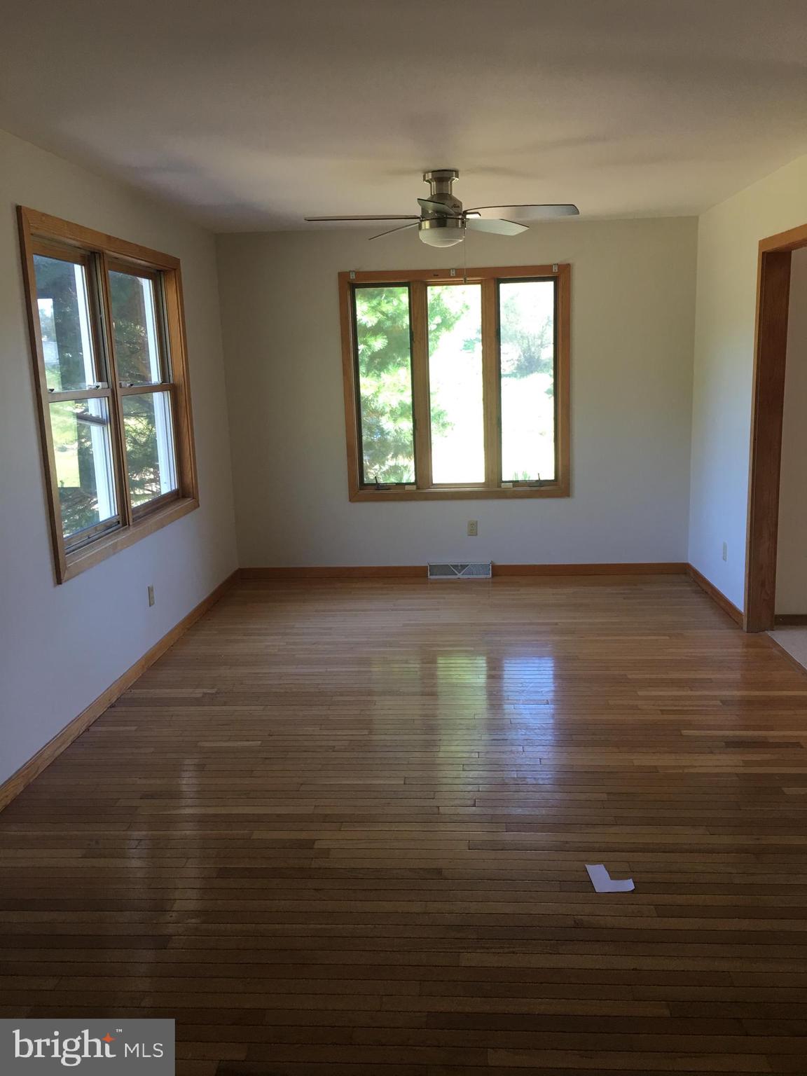 561 Mullica Hill Road Glassboro, NJ 08028 - Photo 12 of 20 an empty room with wooden floor and windows