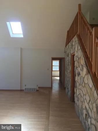 a view of an entryway with wooden floor