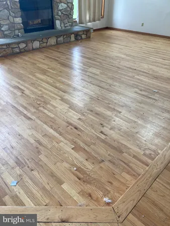 a view of room with wooden floor