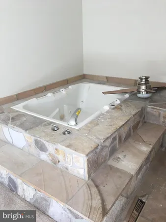 a bathroom with a tub and sink