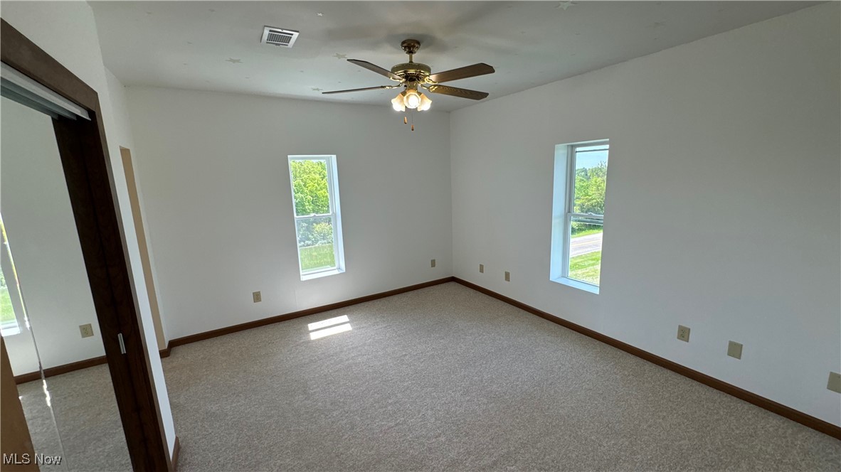 6255 Highland Ridge Road Lowell, OH 45744 - Photo 19 of 40 Unfurnished room featuring a ceiling fan, carpet flooring, and baseboards