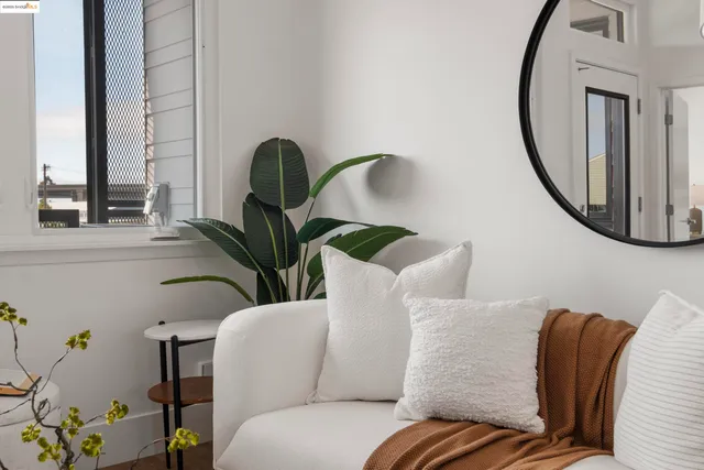 a living room with furniture and a mirror