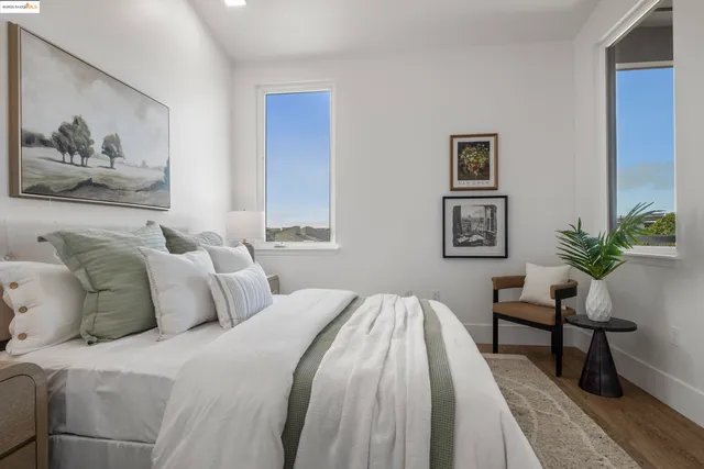 a bedroom with a bed and a painting on the wall